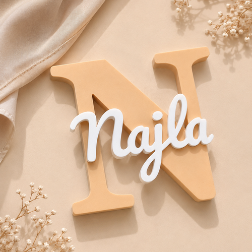 Wooden letter 'N' with 'Najla' on a beige background with dried flowers.